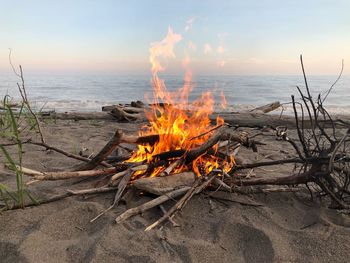 Bonfire on beach against sky