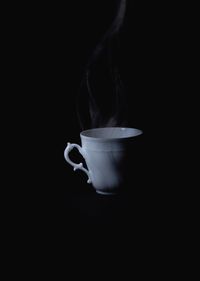 Close-up of coffee cup against black background