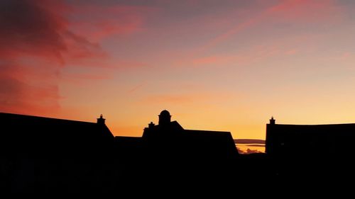 Low angle view of silhouette buildings against sky during sunset