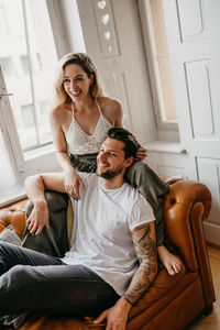 Happy friends sitting at home