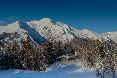 Scenic view of snowcapped mountains against blue sky