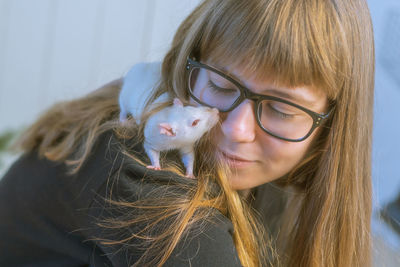 Close-up of smiling girl with rat