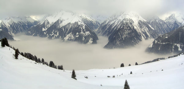 A panoramic view from the mountains of the valley of mayrhofen, covered by a cloud. austria