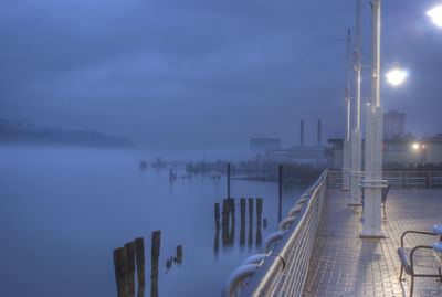 Pier over sea in foggy weather at dusk