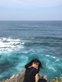 High angle view of woman by sea against sky