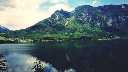 Scenic view of lake and mountains against sky