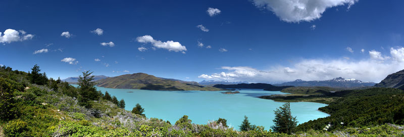 Scenic view of sea and mountains against sky
