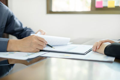 Midsection of business colleagues working at office