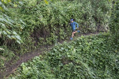 One man running down on a trail surrounded by vegetation in zacatlan