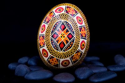 Close-up of multi colored art against black background