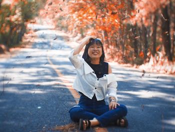 Portrait of smiling young woman sitting in car