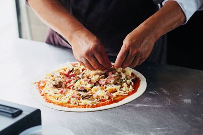 Midsection of man preparing food