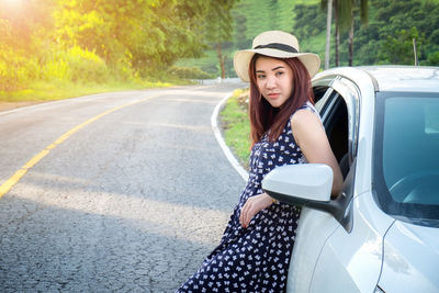 Young woman standing on road