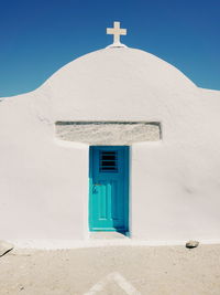 Closed door of church during sunny day