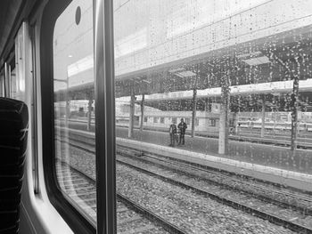 People waiting train at railroad station platform