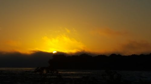 Silhouette landscape against scenic sky