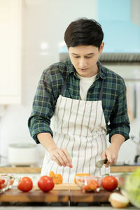 Young man preparing food at home
