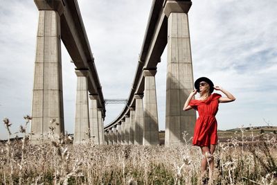 Woman standing with red umbrella