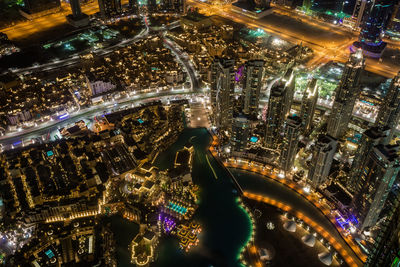 High angle view of city lit up at night