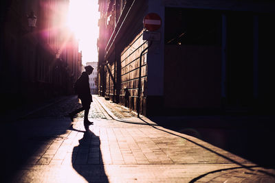 Rear view of man walking on street