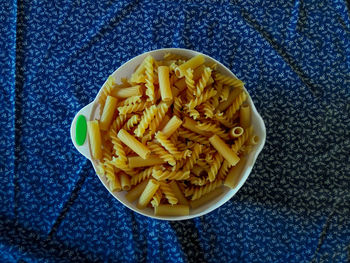 Directly above shot of raw pasta in bowl on table
