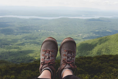 Low section of person against mountains