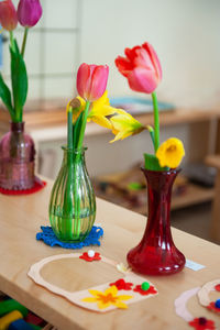 Close-up of tulips in vase on table at home