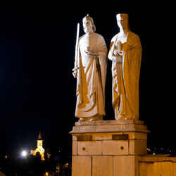 Low angle view of statue against sky at night