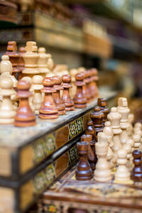 Row of chess pieces on board at store for sale