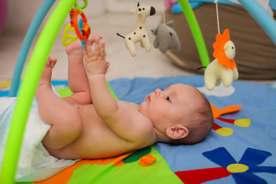 Cute baby boy lying on toy