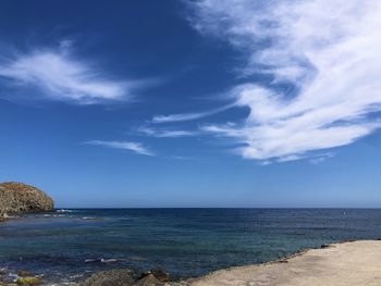 Scenic view of sea against blue sky