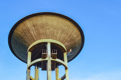 Low angle view of water tower against clear sky