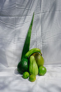 High angle view of green chili peppers on bed