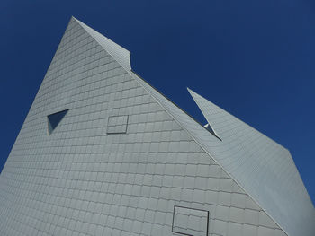 Low angle view of modern building against clear blue sky