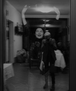 Full length portrait of woman standing in corridor