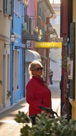 Portrait of woman standing in city