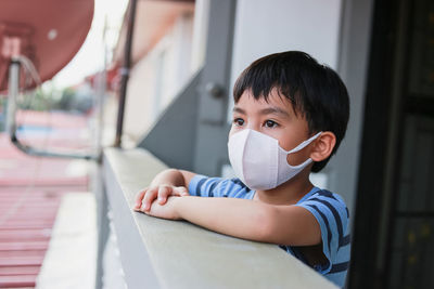  staying at home distance to stop the spread of covids 19 portrait of a child wearing a mask 