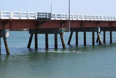 Pier over sea against clear sky