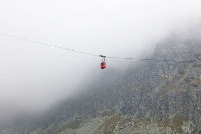 Overhead cable car against sky during winter