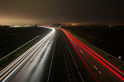 High angle view of light trails on highway at night