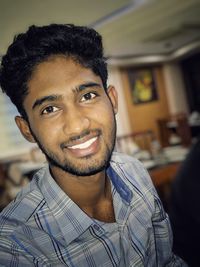 Portrait of smiling young man at home