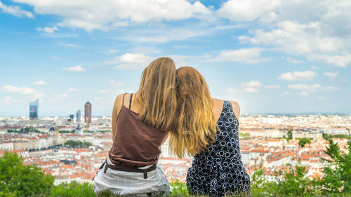 Rear view of woman looking at cityscape