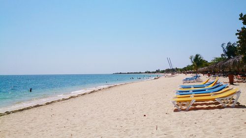 Scenic view of beach against clear blue sky