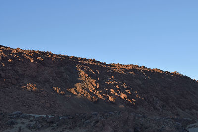 Scenic view of mountain against clear blue sky