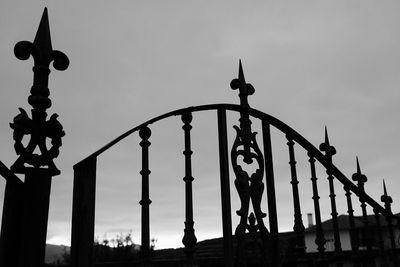 Low angle view of gate against sky