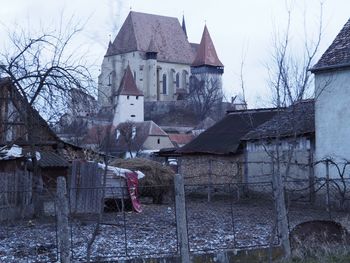 Houses against sky during winter