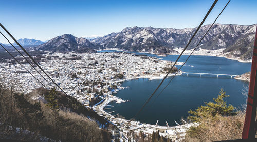 High angle view of cable car against cityscape by lake