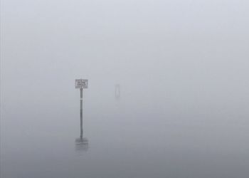 Scenic view of lake in foggy weather