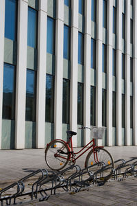 Bicycle parked on sidewalk by building