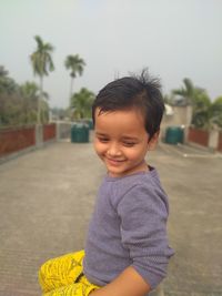 Portrait of cute boy standing outdoors